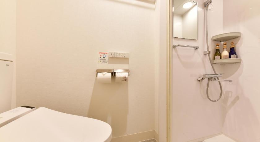 a bathroom with a toilet, sink, and shower stall, Vessel Inn Sakae Ekimae in Nagoya