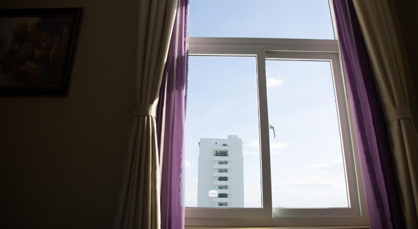 a window with a view of a city, Hai Ba Trung Hotel and Spa in Buon Ma Thuot