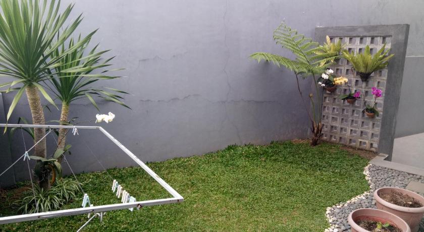 a garden hose sitting on the side of a fence, Homestay Syariah Cileunyi, Bandung Timur in Bandung