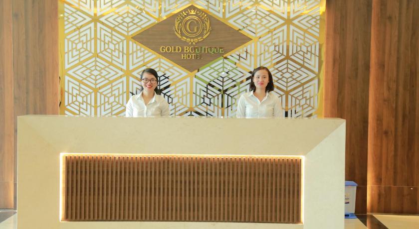 two men standing next to each other in front of a wall, Gold Boutique Hotel in Da Nang