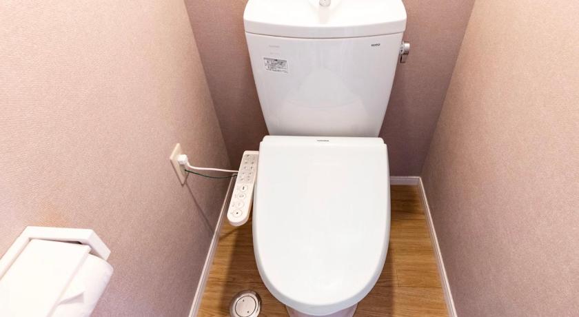 a white toilet sitting next to a white wall, Mr.KINJO in ASATO in Okinawa Main island