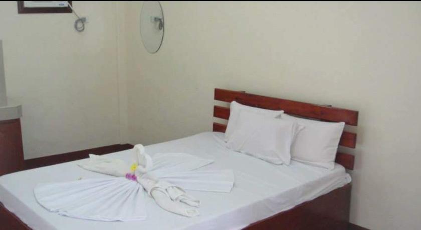 a white bed with a white comforter and pillows, AJ Travellers Inn Annex in Boracay Island