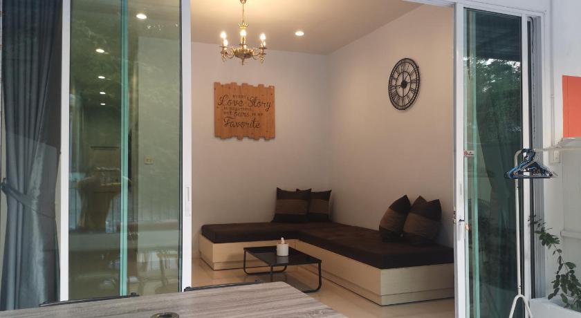 a living room filled with furniture and a large window, Samed Yours House in Ko Samet