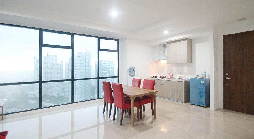 a kitchen with a dining room table and chairs, Apartemen Veranda Residence at Puri Kembangan by Aparian in Jakarta