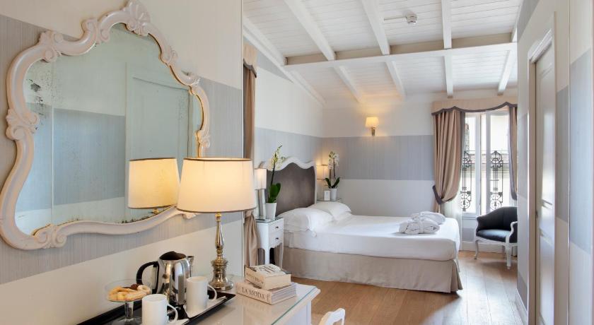 a hotel room with a large mirror and a large bed, Hotel Rapallo in Florence