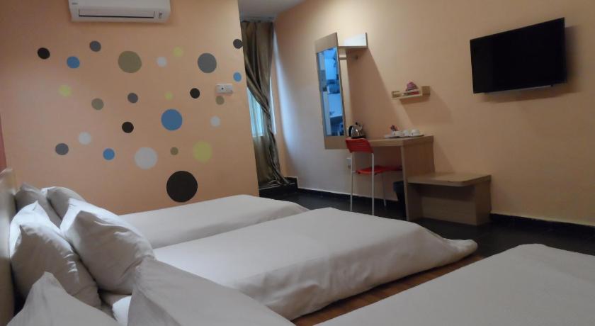 a hotel room with a bed and a television, JS Hotel in Johor Bahru