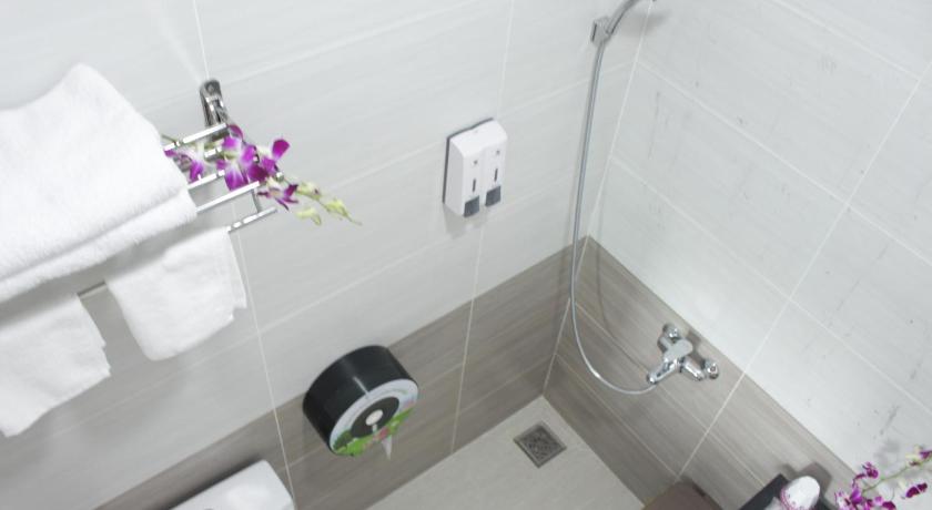 a bathroom with a toilet, sink, and shower stall, DRAGON HOTEL 1 in Ho Chi Minh City