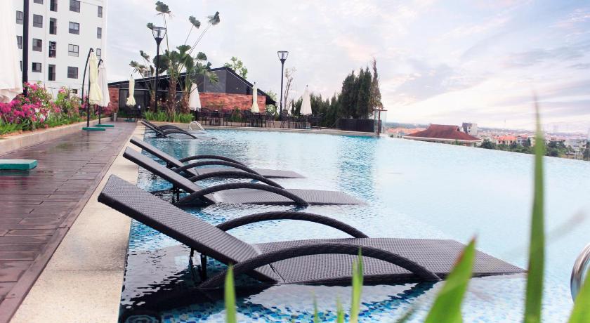 a row of benches in front of a pool of water, Mandala Hotel & Spa Bac Ninh in Bac Ninh
