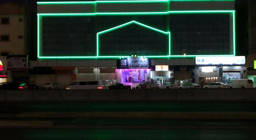 a building with a neon sign on top of it, Al Eairy Apartments Al Qassim 1 in Buraydah