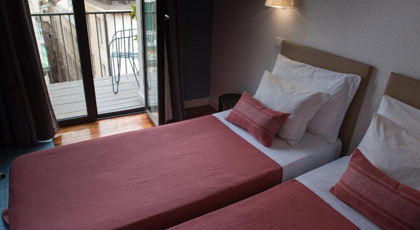 a hotel room with two beds and two windows, B&B Attico Partenopeo in Naples