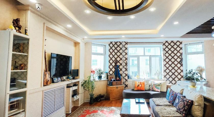 a living room filled with furniture and a tv, Top Tour & Guesthouse Mongolia in Ulaanbaatar