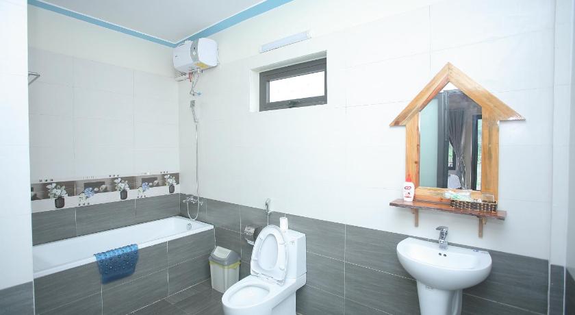 a bathroom with a toilet a sink and a bath tub, Restful River Bungalow in Đồng Hới (Quảng Bình)