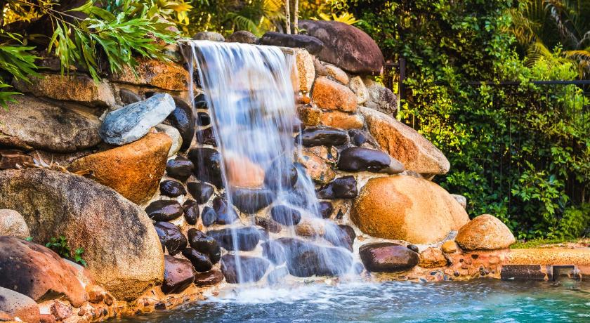 a waterfall that has a waterfall in it, Malanda Lodge in Atherton Tablelands