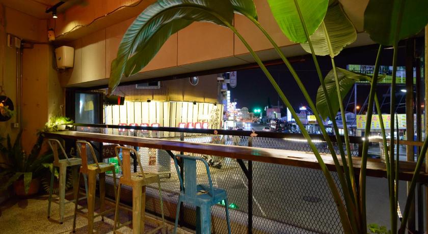 a large outdoor area with benches and umbrellas, Hualien Wow Hostel in Hualien