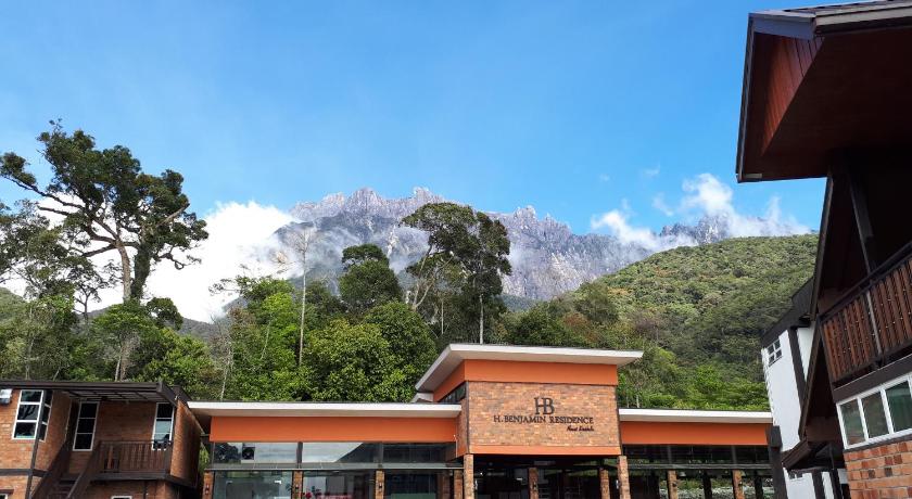 a large building with a clock on top of it, H Benjamin Residence in Kinabalu National Park