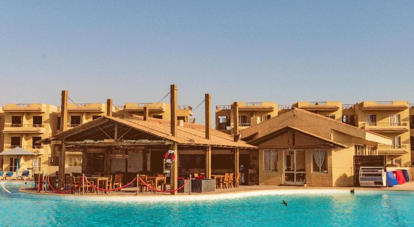 a hotel room with a large swimming pool, Regina Resort El Sokhna in Ataqah