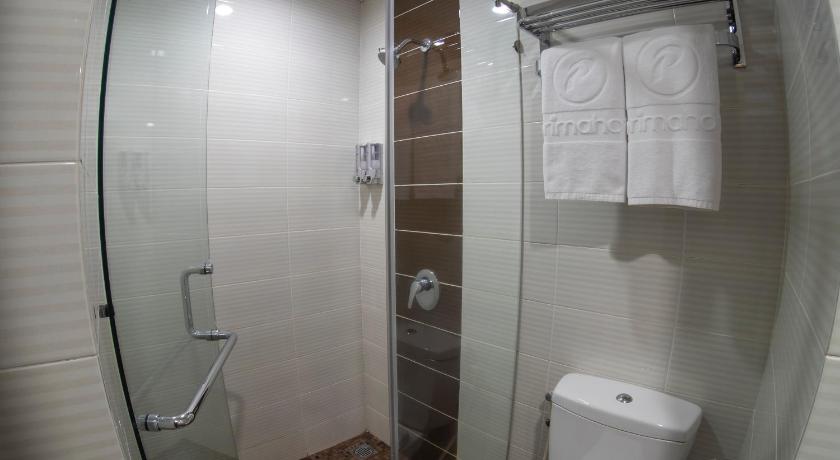 a bathroom with a shower, toilet, and sink, d'primahotel ITC Mangga Dua in Jakarta