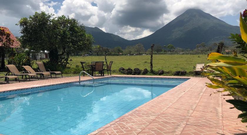 a horse standing in front of a pool of water, Hotel Villas Vista Arenal in La Fortuna