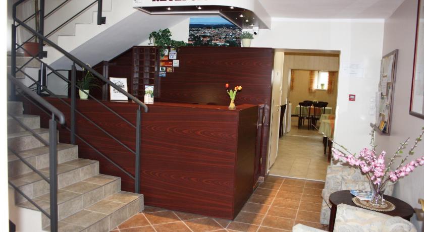 a room with a staircase leading to a stair case, Polus Pension in Sopron