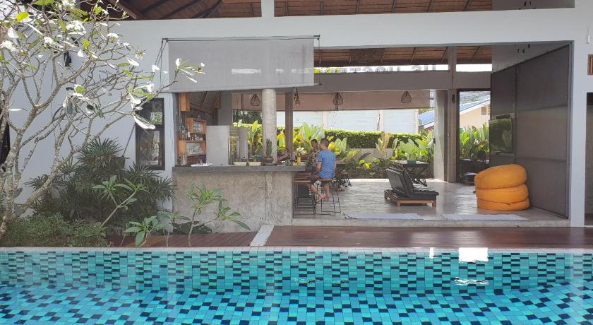 a large room with a pool and a tub, Us Hostel in Koh Samui