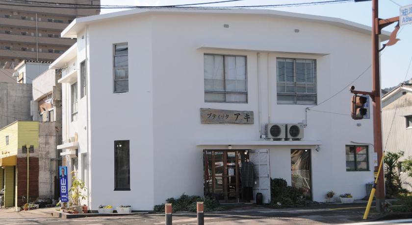 a large white building with a large window, Guest House Aki in Nichinan