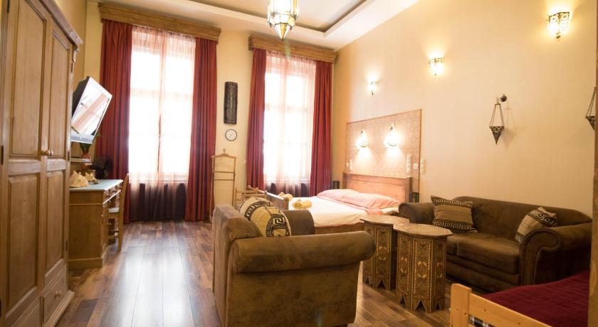 a living room filled with furniture and a fireplace, Budapest Royal Suites in Budapest
