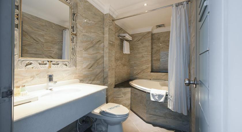 a bathroom with a sink, toilet and bathtub, A&EM Corp - The Petit Hotel in Ho Chi Minh City