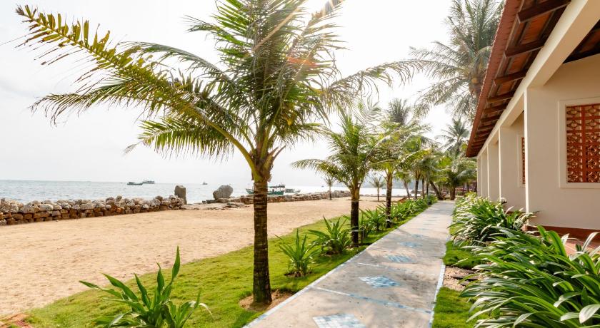 a beach with palm trees and palm trees, Hula Hula Beachfront Phu Quoc in Phu Quoc Island