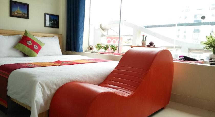 a hotel room with a bed and a chair, Chau A Hotel in Hai Duong