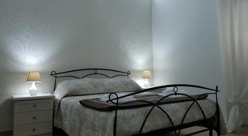 a bedroom with a bed and a lamp, B&B da Mammina in Taranto