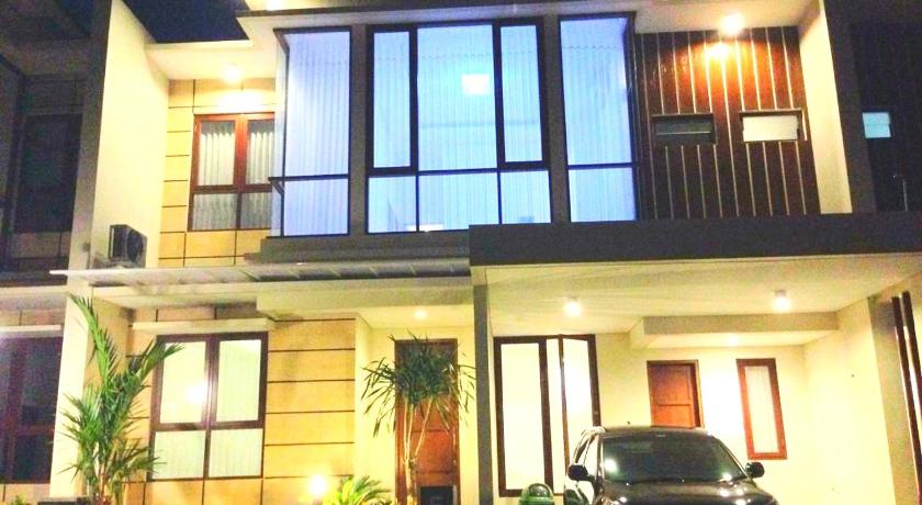 a car parked in front of a house with a window, Fam's Homestay By FH Stay in Yogyakarta