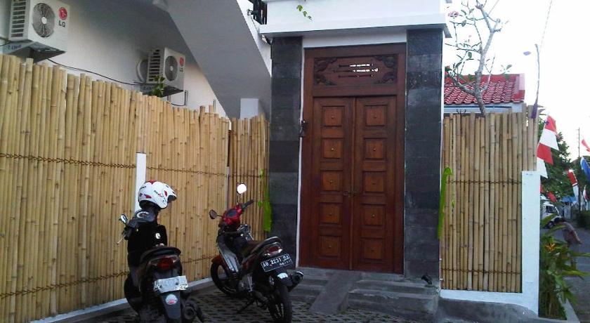 a motorcycle is parked in front of a building, The Wayang Homestay in Yogyakarta