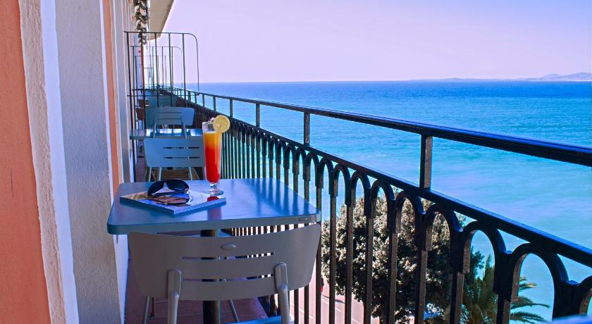 a view from a balcony of a balcony overlooking the ocean, Hotel Suisse in Nice
