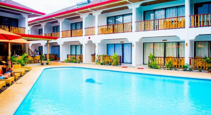 a hotel room with a pool and a balcony, Alona Vida Beach Hill Resort in Bohol