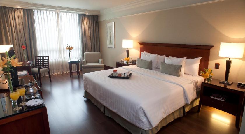 a hotel room with a large bed and a large window, Regal Pacific Puerto Madero in Buenos Aires