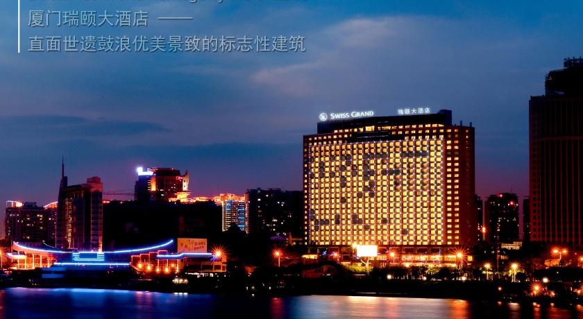 a large building with a clock on top of it, Swiss Grand Xiamen in Xiamen