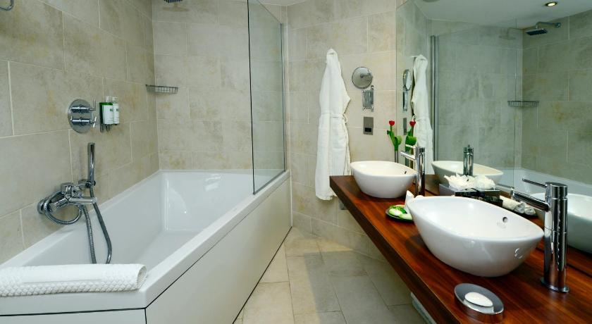 a bathroom with a tub and a sink, Rocpool Reserve Hotel and Chez Roux Restaurant in Inverness
