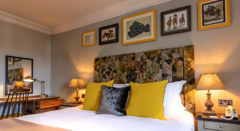 a bedroom with a large bed and a painting on the wall, The Foley in London