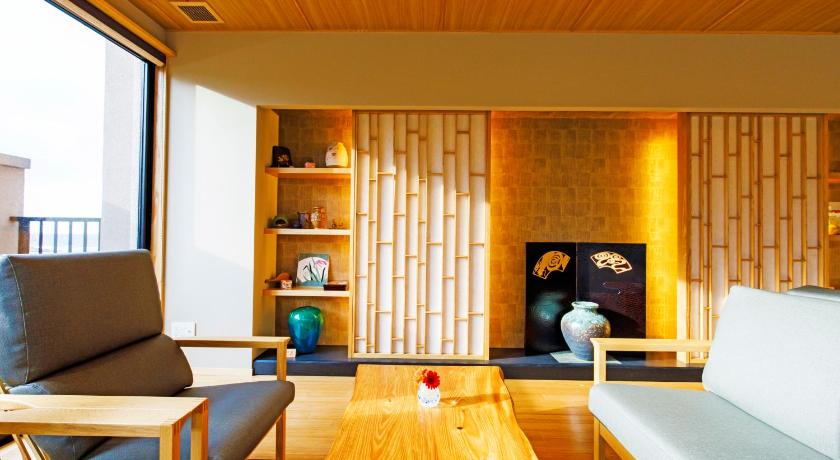 a living room filled with furniture and a fire place, Umino Ryotei Okinawa Nakamasou in Okinawa Main island