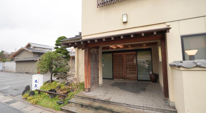 a building with a door open on the side of the building, Onsenryokan Marumo in Tottori