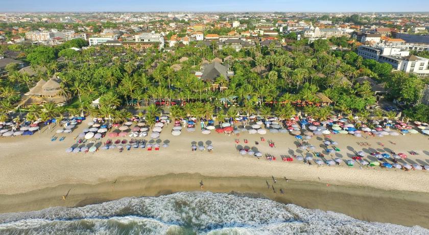 a beach filled with lots of palm trees, Legian Beach Hotel in Bali