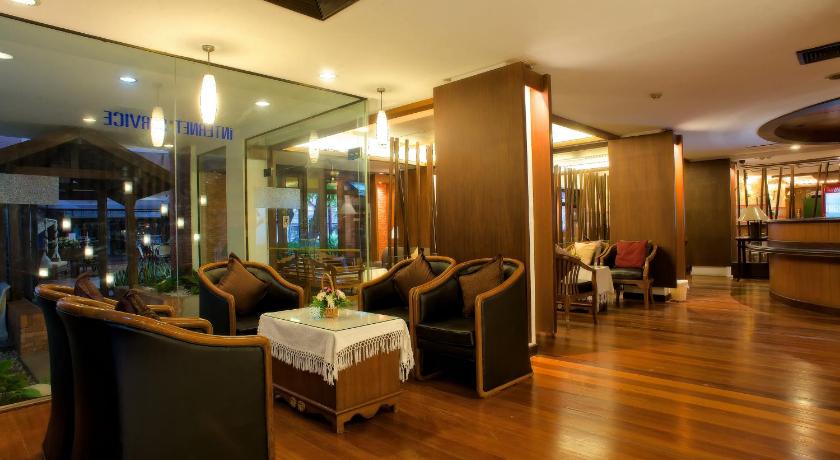 a living room filled with furniture and a large window, Chiangmai Gate Hotel (SHA Plus+) in Chiang Mai