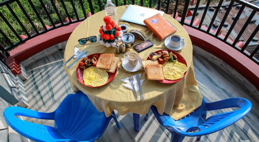 a table topped with plates of food on top of a picnic table, Sunset guest house in Pokhara