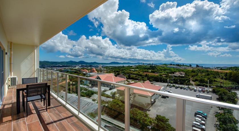 a view from a balcony of a balcony overlooking a city, Lieta Nakayama in Okinawa Main island