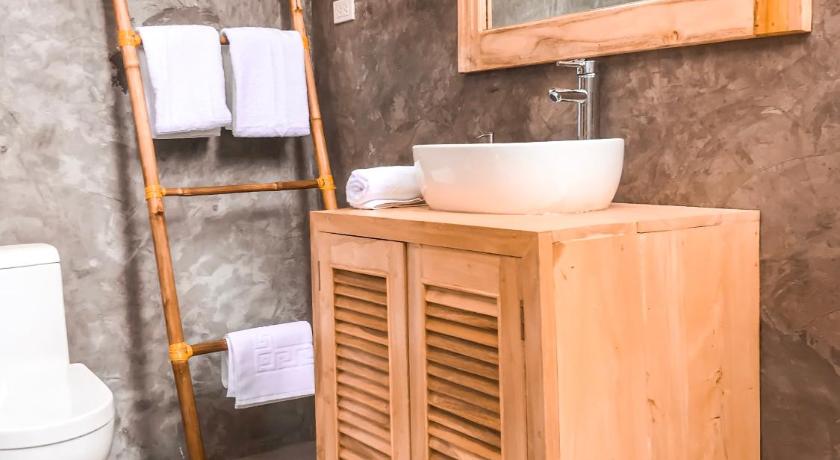 a bathroom with a sink and a toilet, Bermuda Triangle Bungalows in Siquijor Island