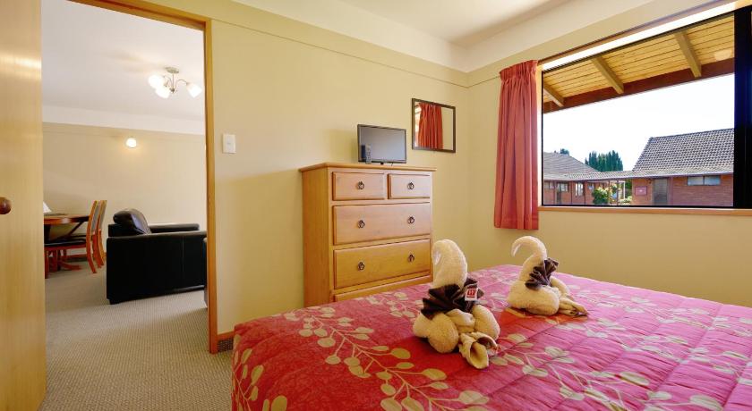 a stuffed animal sits on a bed in a hotel room, Mosgiel Regency Motel in Dunedin