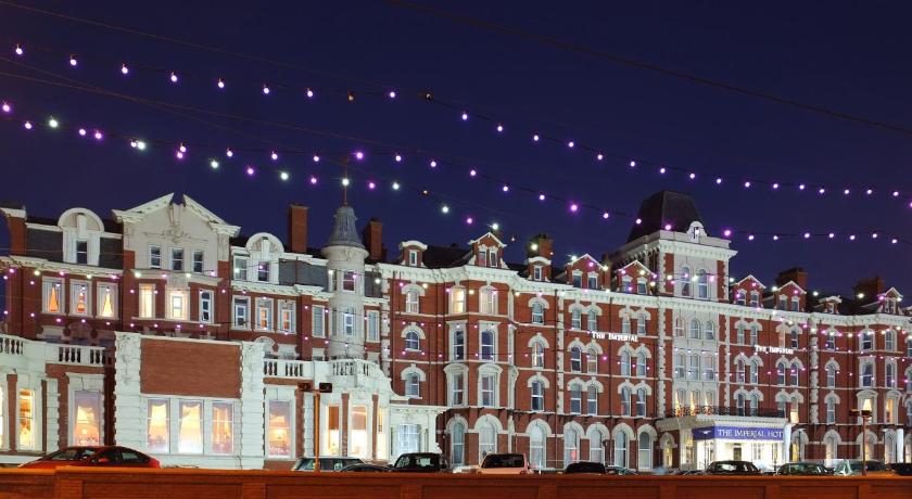 a large building with a large clock on the front of it, Imperial Hotel Blackpool in Blackpool