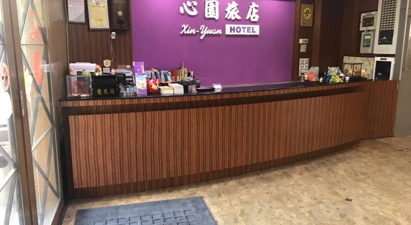 a large counter with a large sign on it, Xin Yuan Hotel in Hsinchu
