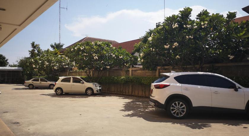 a car parked in a parking lot next to a building, Sab Suwarn Mansion in Suphan Buri