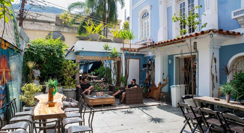 a restaurant with tables and chairs in front of a building, Aurora Hostel Rio in Rio De Janeiro